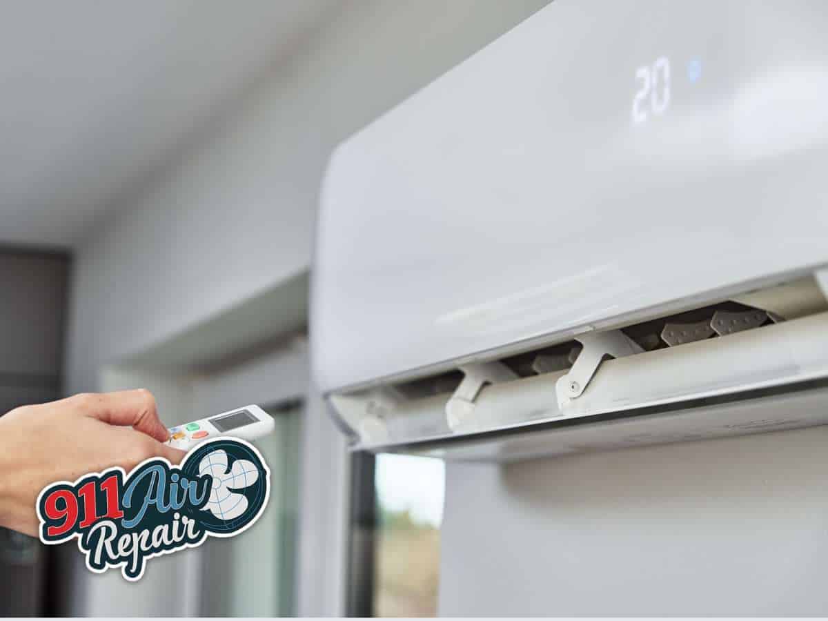 Person using a remote to turn on an air conditioner, ensuring cool comfort indoors